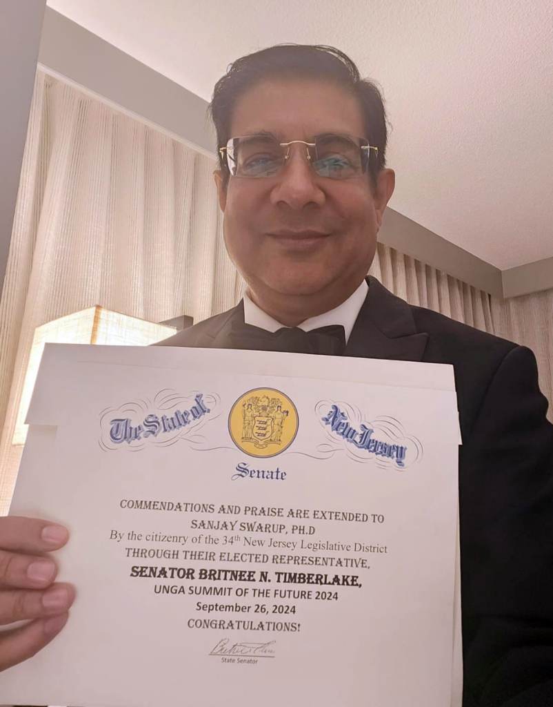 NERI Director, Associate Professor Sanjay Swarup posing with the Certificate of Commendation from UNGA Summit of the Future